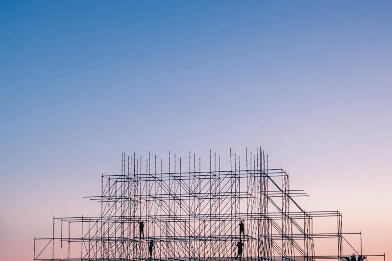 Scaffolding on a construction site at sunset